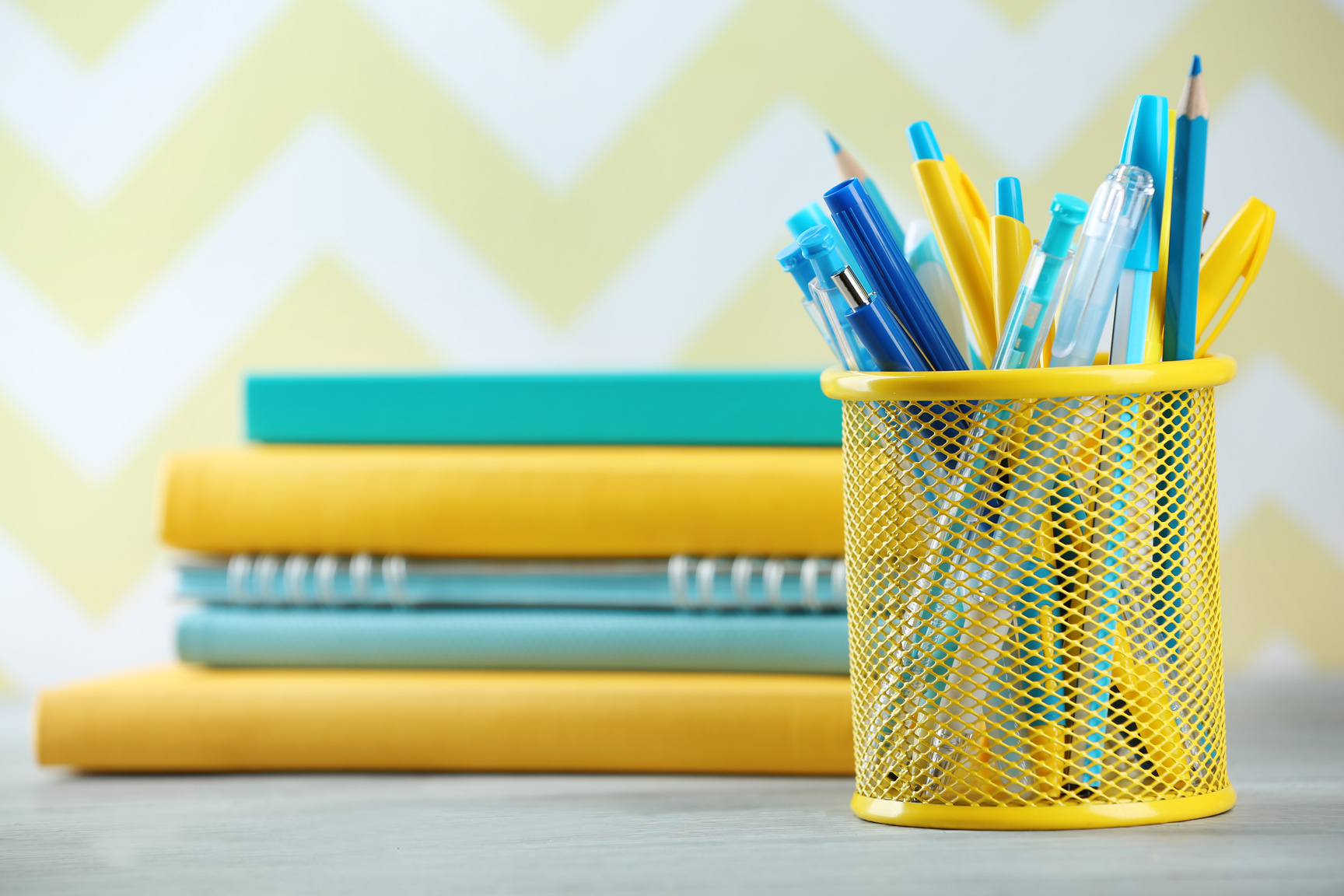 Pens in Metal Holder and Books